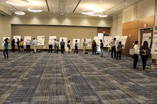 All Hands Meeting poster session with people visiting the posters.