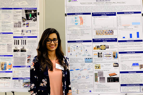 Sachindra Thippalagamage, graduate student in the Soper group, standing by a research poster.