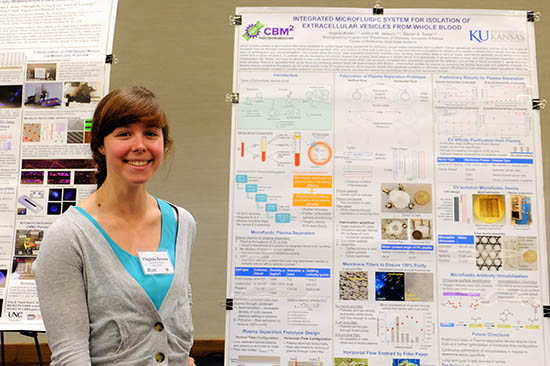 Virginia Brown, graduate student in the Soper group, standing by a research poster.