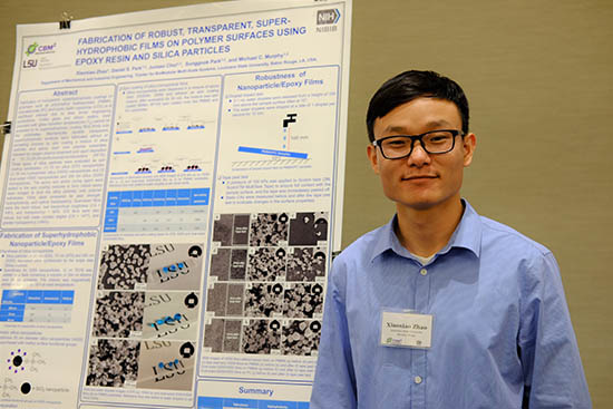Xiaoxiao Zhao, graduate student in the Murphy group, standing by a research poster.