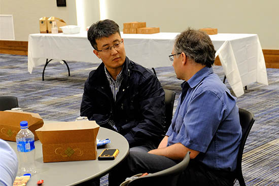 Daniel Park, post-doc in the Murphy group, chats with Matt Hupert of BioFluidica over the lunch break