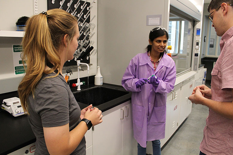 Graduate student Harshani Wijerathne demonstrates using a toothbrush and water to clean the chips