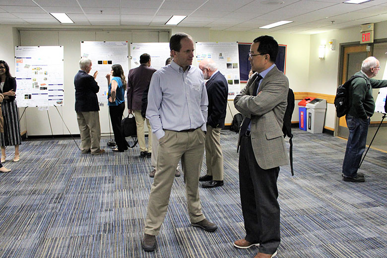 EAB member Dr. Bruce Gale talks with Dr. Sunggok Park during the poster session