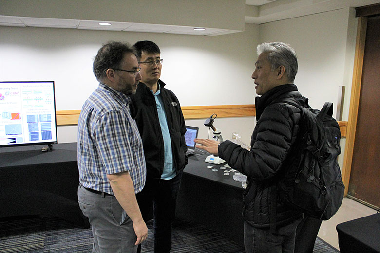 Collaborator Dr. Daniel Chiu (right) talks with Dr. Matt Hupert (left) and Dr. Daniel Park (center)
