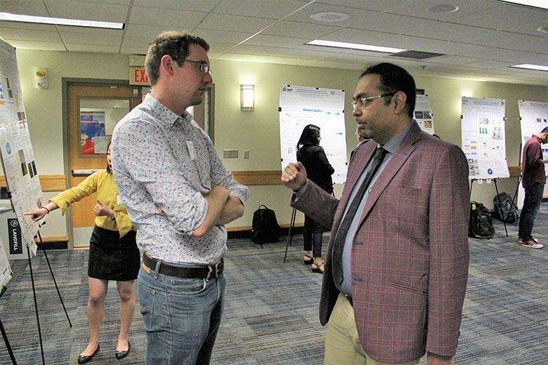 Postdoctoral researcher Dr. Matt Jackson (left) listens to collaborator Dr. Subhrajit Saha (right)