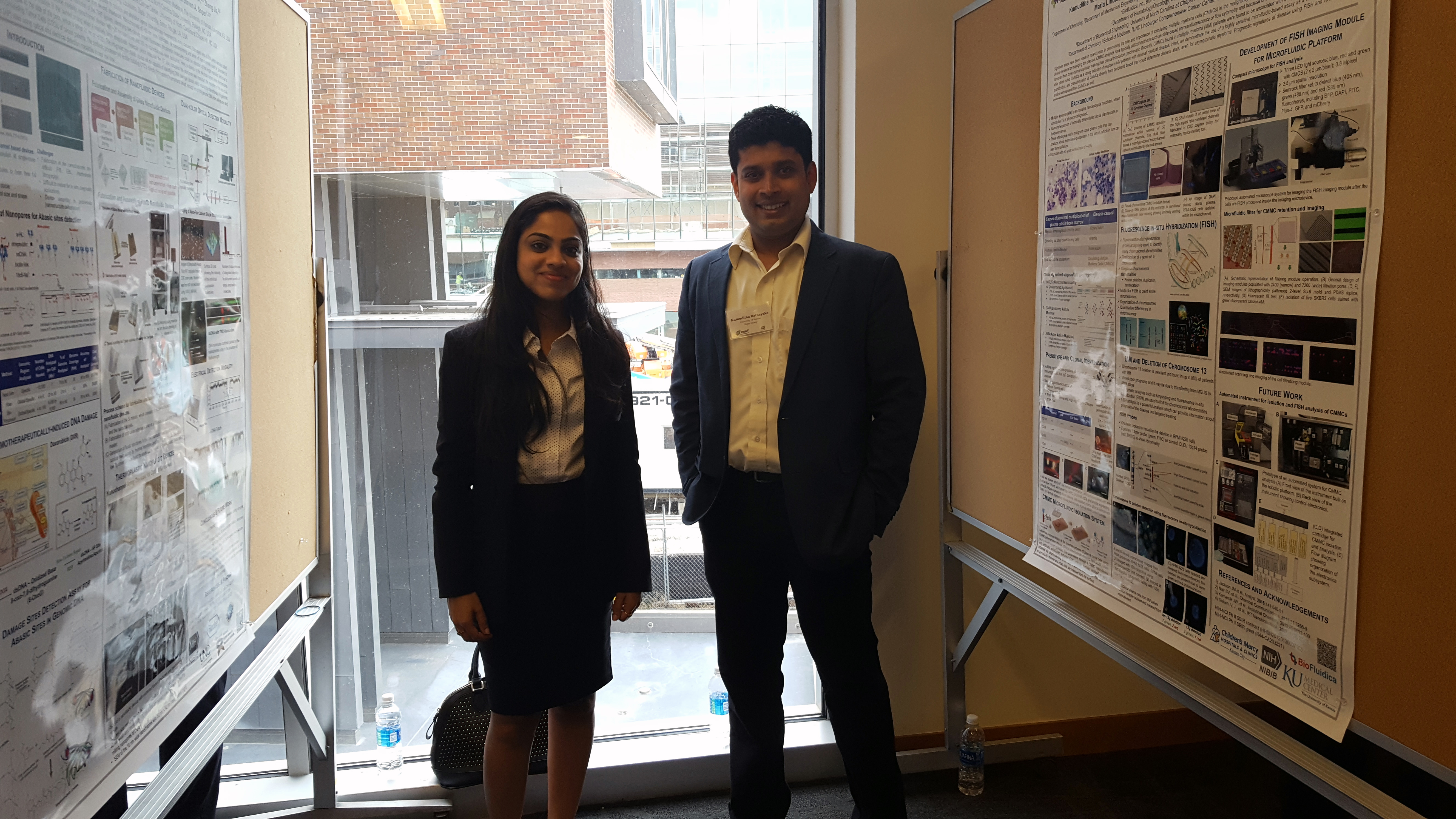 Two people standing by research posters.