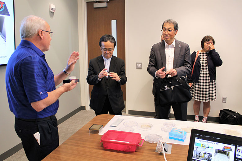 Dr. Ueda and Mr. Kaito receive microfluidic chips from Dr. Soper