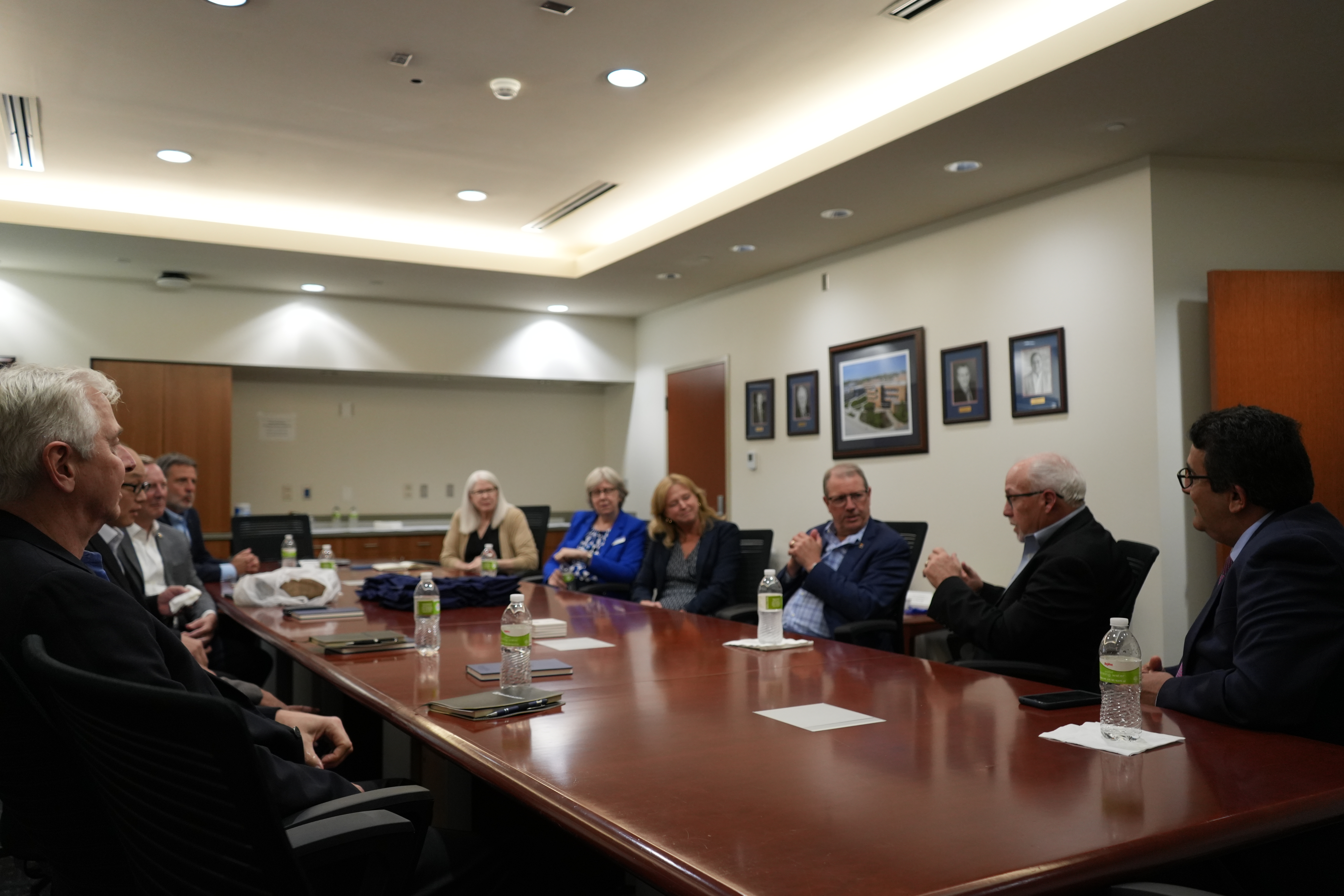 "group photo of a meeting a a full conference room table between members of the shimadzu corporation KU economic development and involved department faculty"