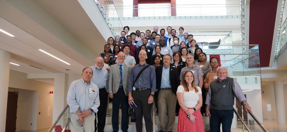 CBM2 team posing for a photo on a staircase.