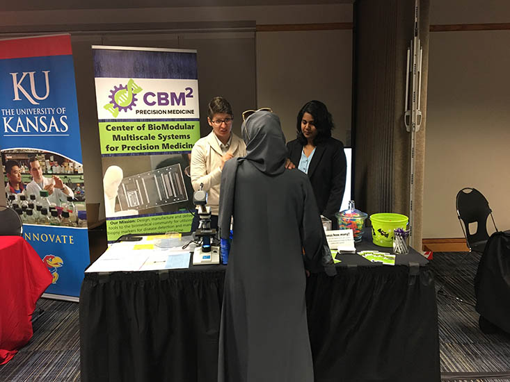 Dr. Bethany Gross and Charuni Amarasekara explain the Center’s research to an interested meeting attendee.